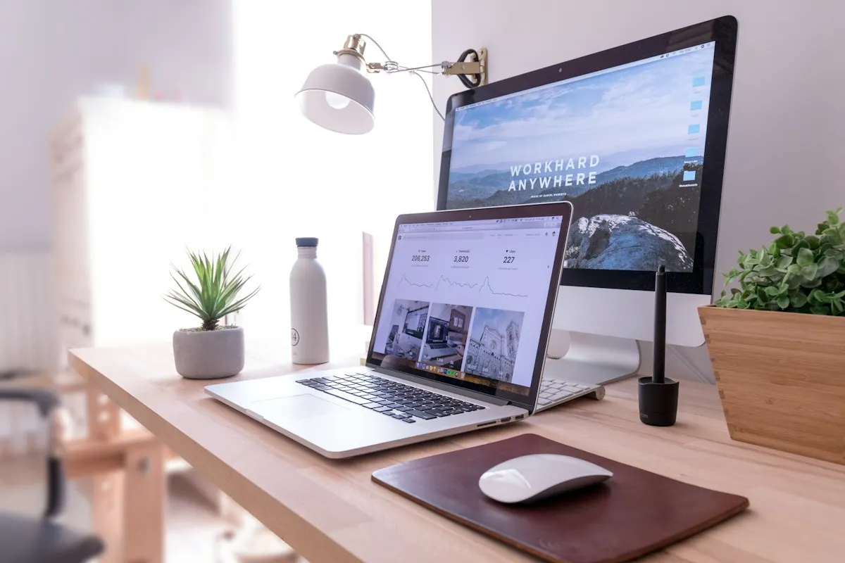 Website design workspace with laptop and desktop screens